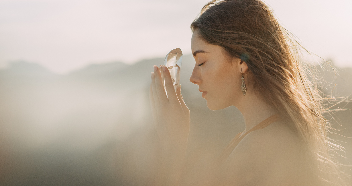 Woman's head with a healing crystal